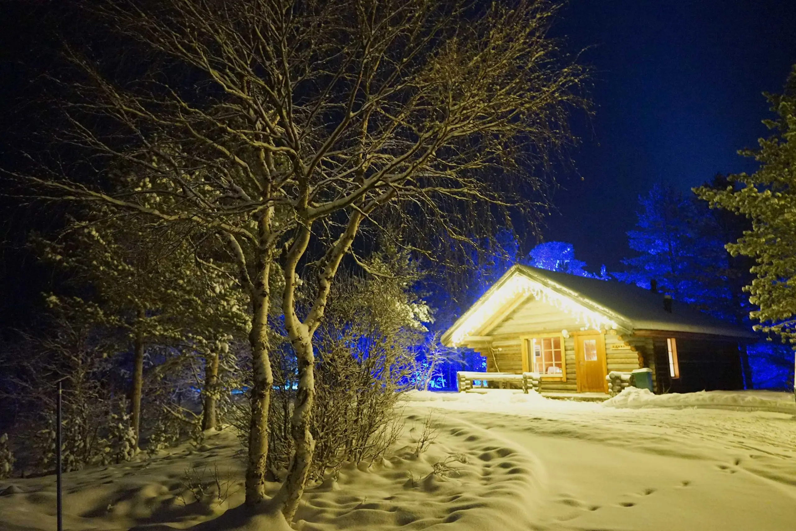 Kiiruna lodge lit up on a snowy winter evening