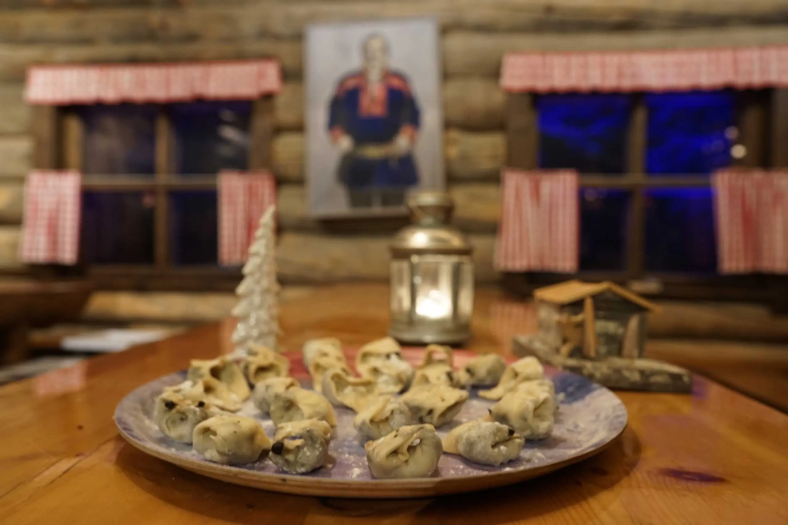 A plate of homemade dumplings on a wooden table in the log restaurant